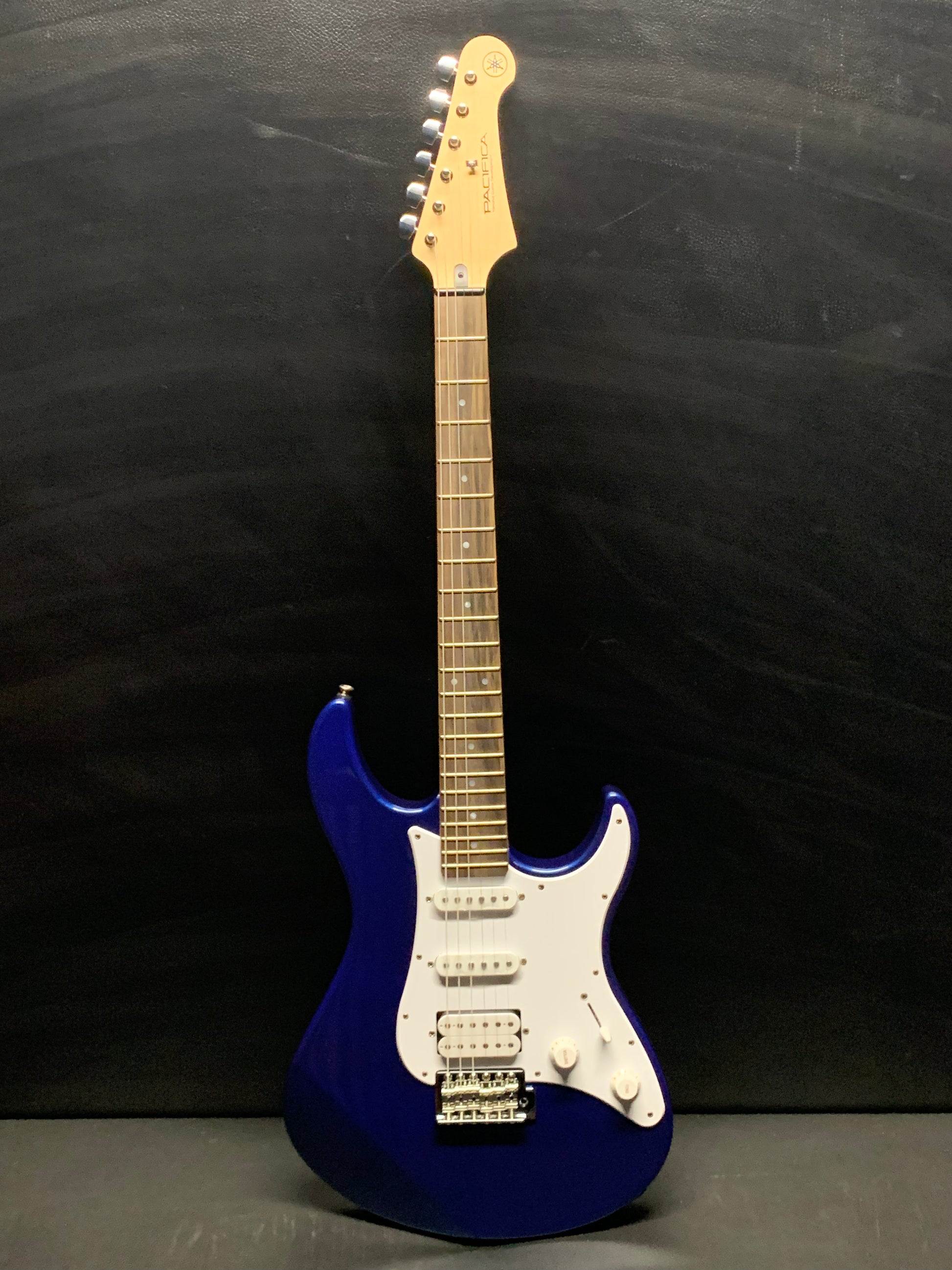 Yamaha Pacifica 012 electric guitar with HSS pickups, maple neck, and vintage tremolo bridge.