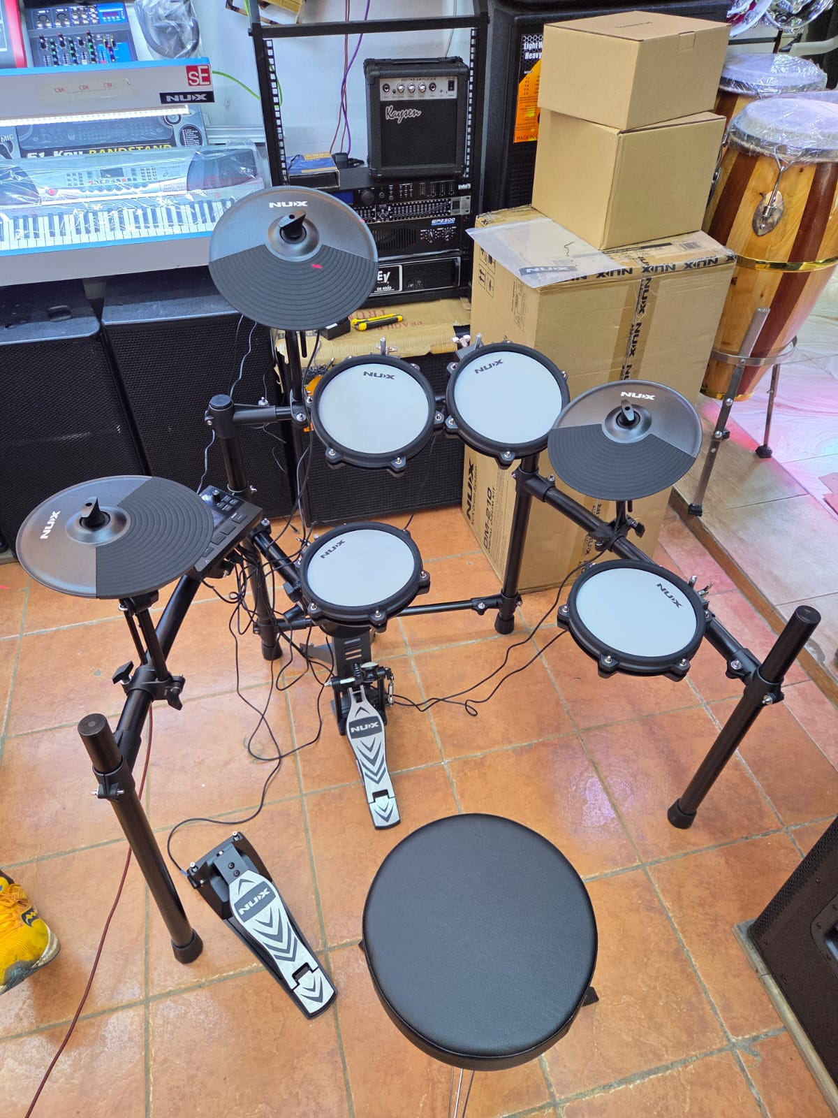 NUX DM-210 all-mesh electronic drum kit with dual-zone mesh pads, Bluetooth audio, USB MIDI, and kick tower available at Musicland Music Shop.