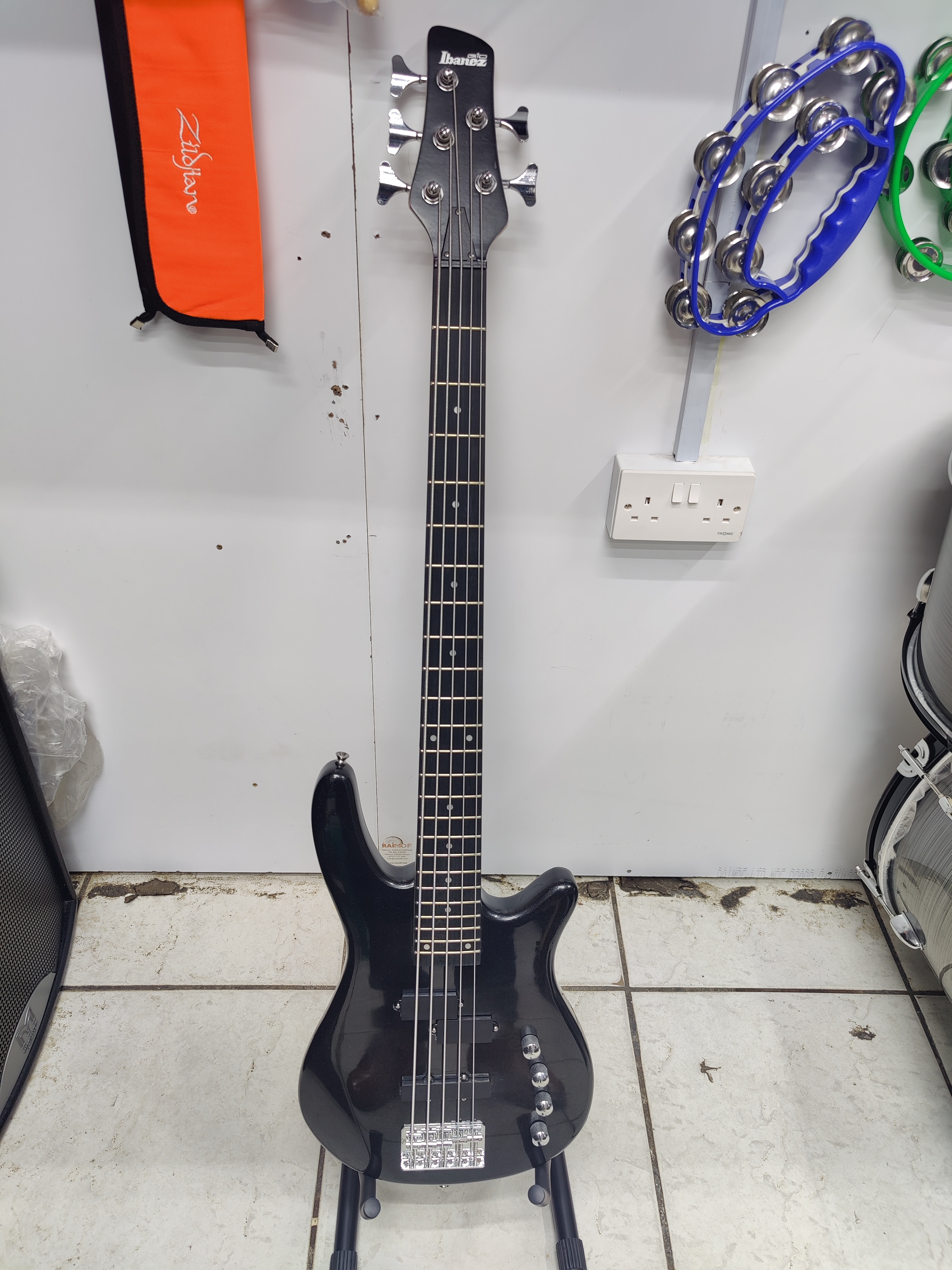 Here's a website-ready description for a Passive Ibanez 5-String Bass Guitar: Ibanez Passive 5-String Bass Guitar Expand your musical range with the Ibanez Passive 5-String Bass Guitar, a versatile instrument built for powerful performance and exceptional comfort. Featuring a passive pickup configuration, this bass delivers a warm, natural, and dynamic tone that responds beautifully to your playing style. The slim Ibanez neck and ergonomic body design provide outstanding comfort and fast playability, making it ideal for long rehearsals, studio sessions, and live performances. The additional low B string gives you extended range, making this bass perfect for gospel, jazz, rock, funk, pop, and contemporary worship music. With durable chrome hardware, a stable bridge, and reliable tuning machines, the Ibanez Passive 5-String Bass Guitar is designed to perform consistently while delivering the legendary quality and playability Ibanez is known for. Features - 5-string electric bass guitar with extended low B string - Passive pickup configuration for warm, natural tone - Slim, comfortable Ibanez neck - Ergonomic, lightweight body design - Durable chrome hardware - Adjustable bridge for accurate intonation - Smooth fingerboard for effortless playability - Ideal for live performances, studio recording, rehearsals, and practice - Suitable for gospel, jazz, rock, funk, blues, and pop Whether you're locking in the groove on stage or recording in the studio, the Ibanez Passive 5-String Bass Guitar offers dependable performance, rich tone, and outstanding value for bassists of all skill levels.SEO Image Title: Ibanez Passive 5-String Bass Guitar SEO Image Alt Text: Ibanez passive 5-string electric bass guitar with chrome hardware, slim neck, and extended low B string for professional performance.